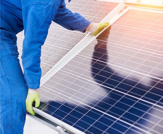 A technician installing solar panels