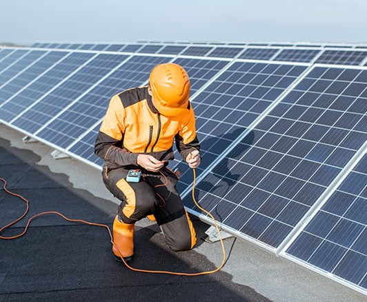 A technician testing solar panels