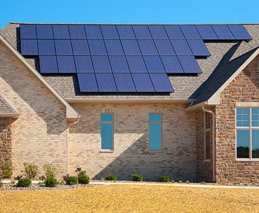 Solar panels on the roof of a brick house