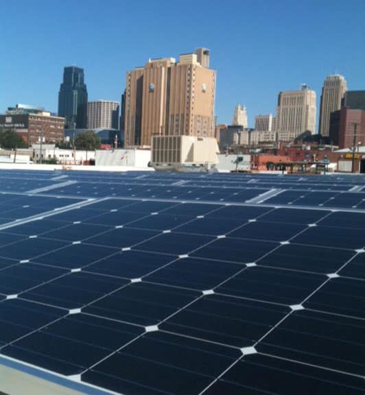 Rooftop mounted solar panels on a city building roof