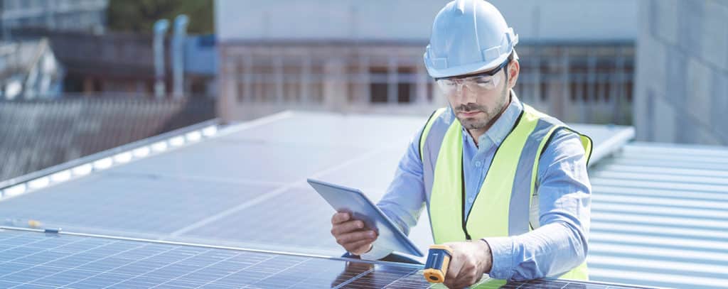 Technician inspecting solar panels