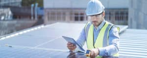 Technician inspecting solar panels