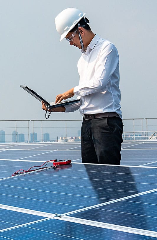 A solar panel inspector on a roof in a city
